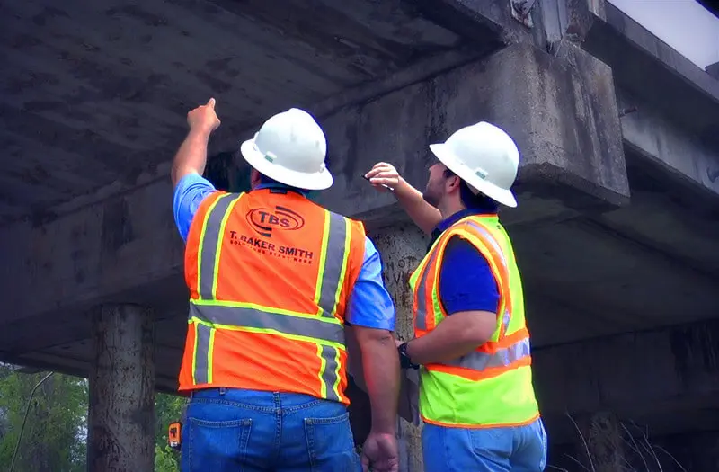 Civil structural engineer and surveyor working on bridge installment