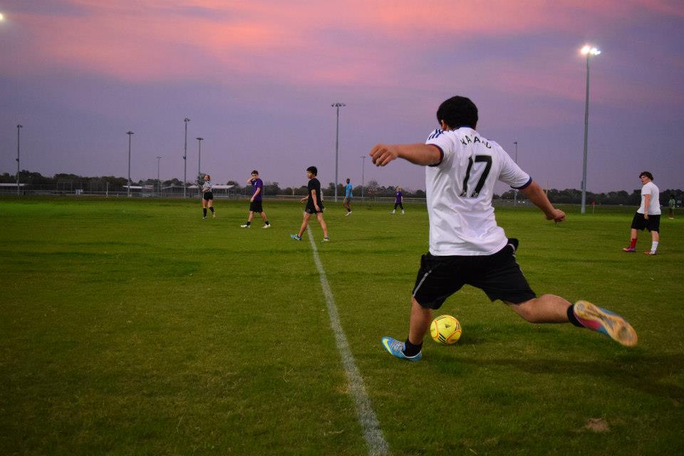 Guy playing soccer at NSU Rec Field