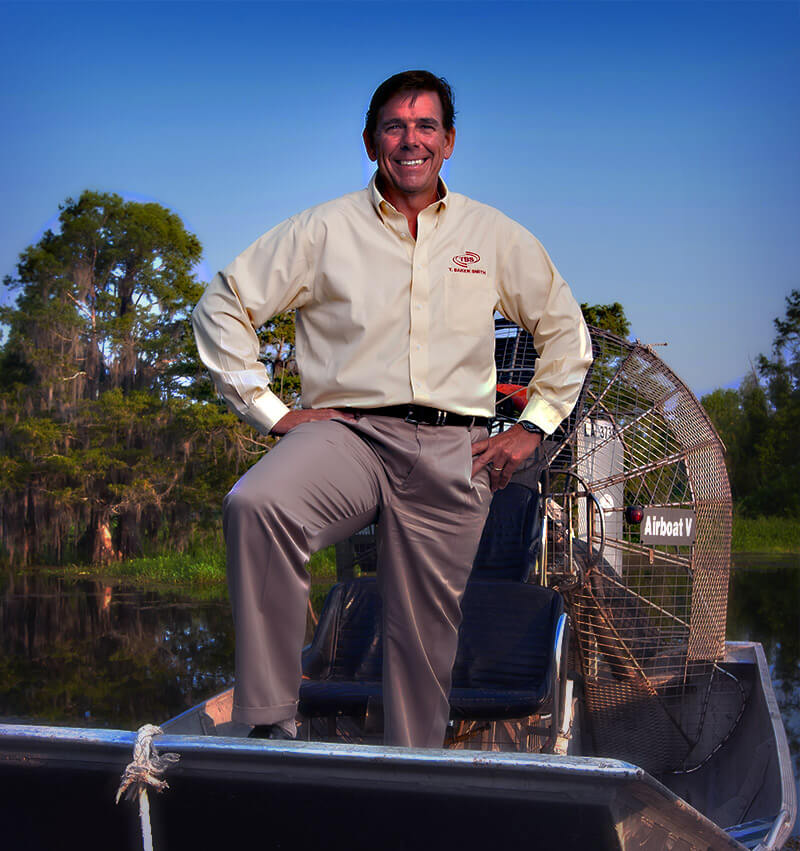 President Kenny standing in swamp boat